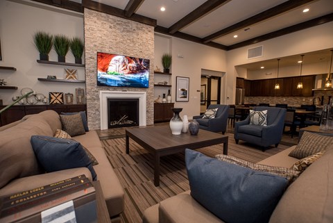 a living room with couches and chairs and a fireplace