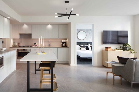 A modern kitchen with a dining table and chairs.