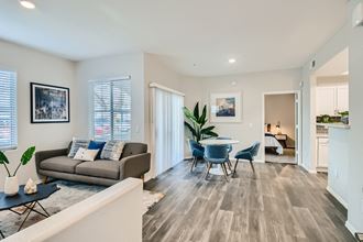 a living room with a couch and a table and chairs