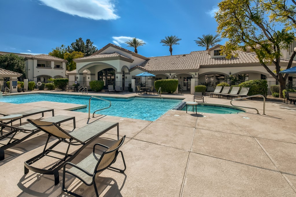 our resort style swimming pool is next to our clubhouse with tables and chairs