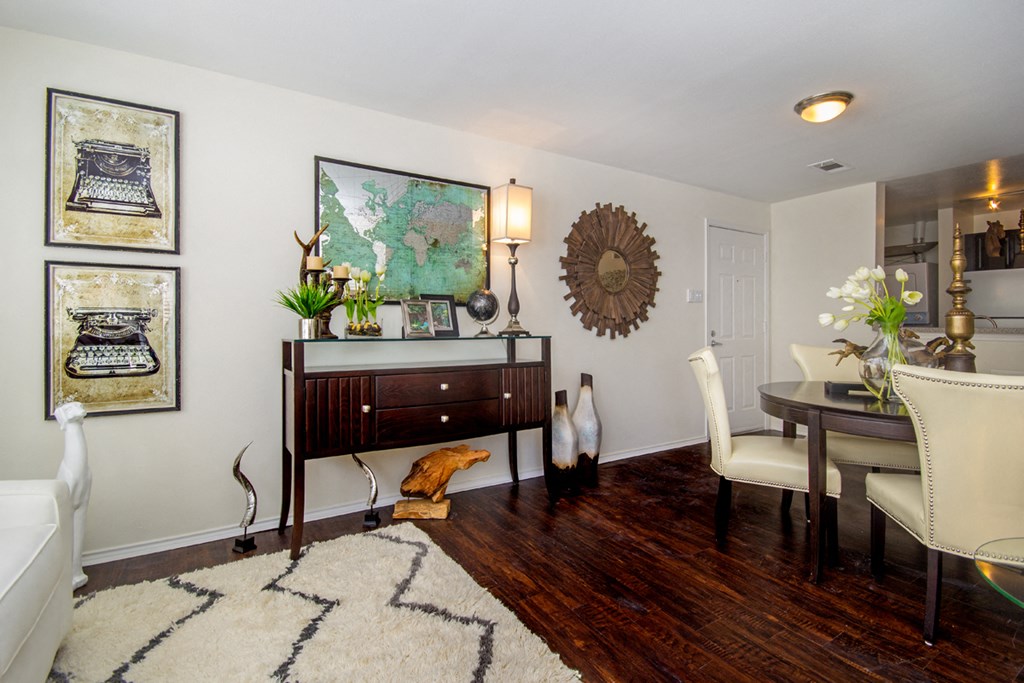 a living room with a dresser and a table
