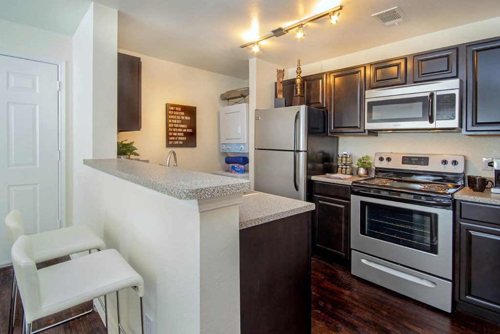 a kitchen with stainless steel appliances and a granite counter top