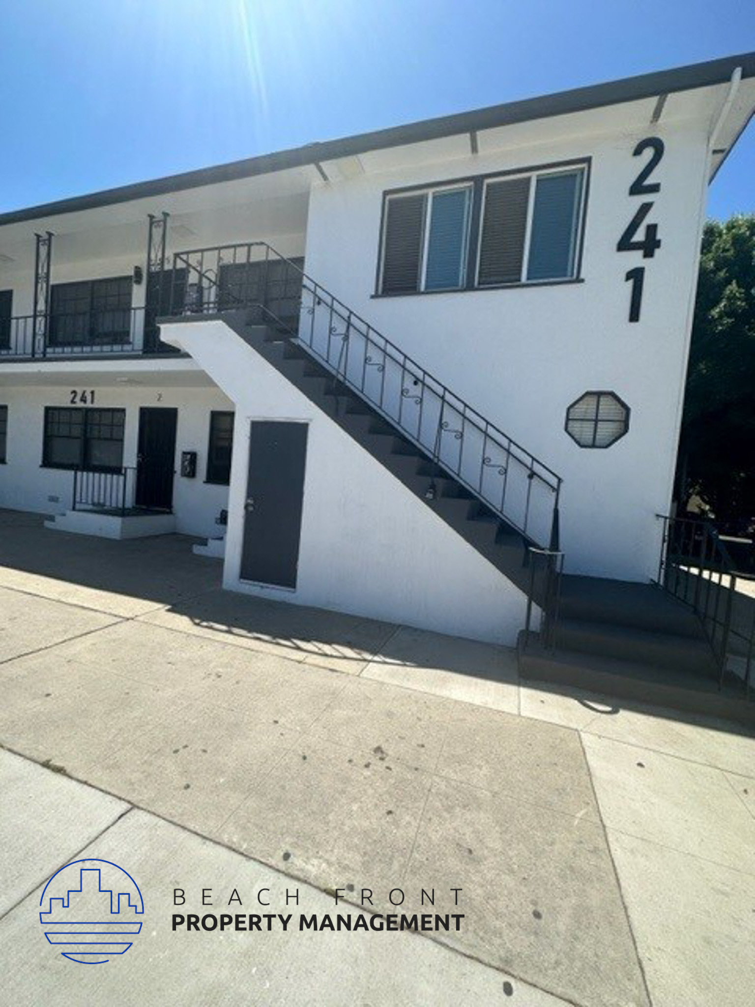 a white building with stairs and a number on it