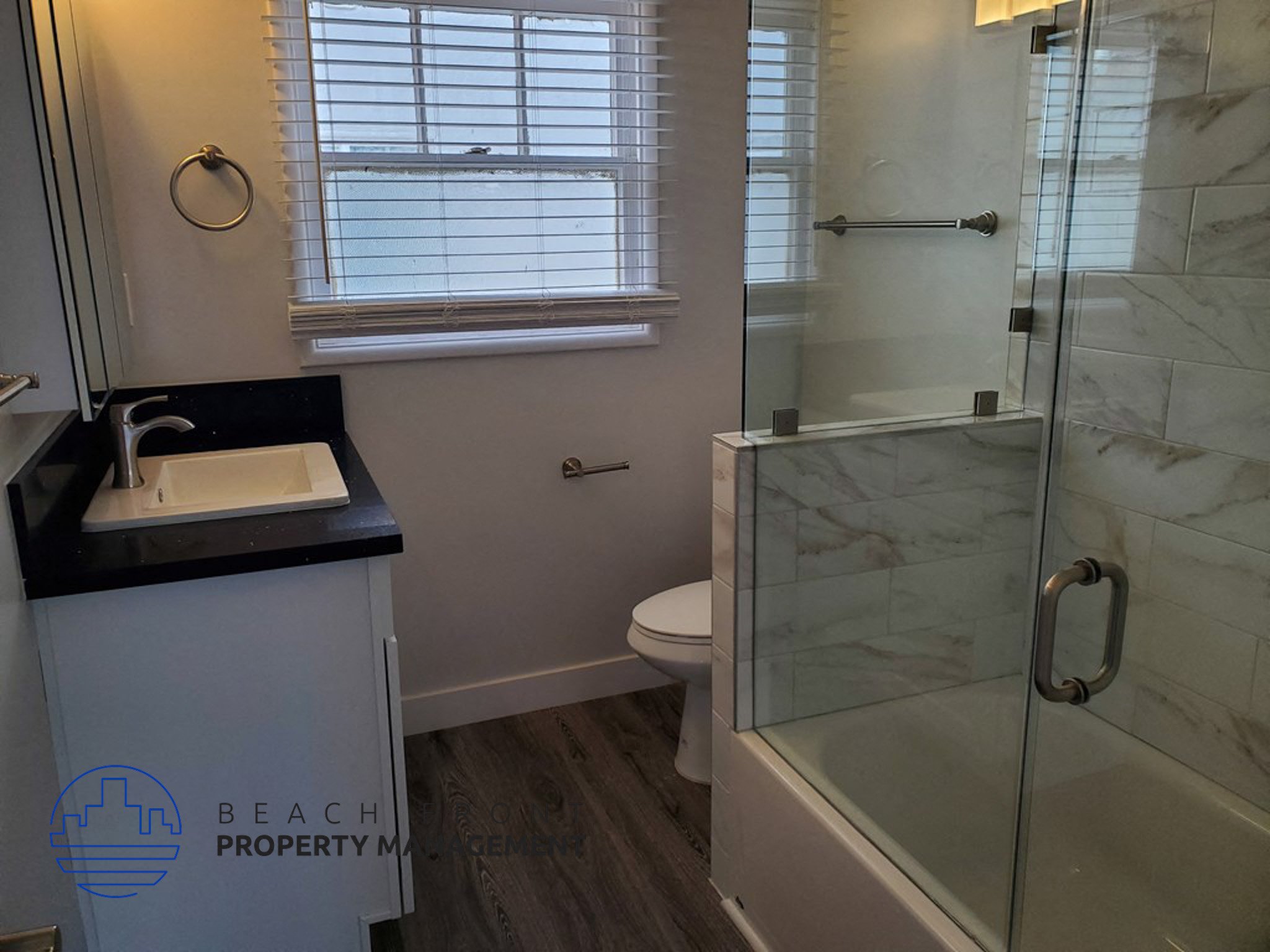 a small bathroom with a sink toilet and shower