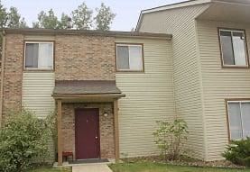 a yellow brick house with a red door