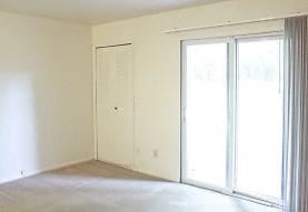 a living room with a large window and a door