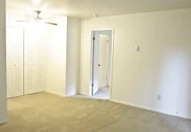 an empty living room with white walls and a door