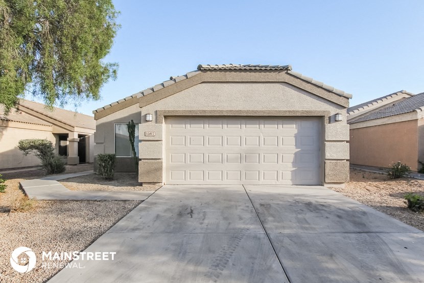 a garage with a white door in front of a house