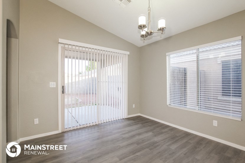 the living room of a new home with a door to the patio