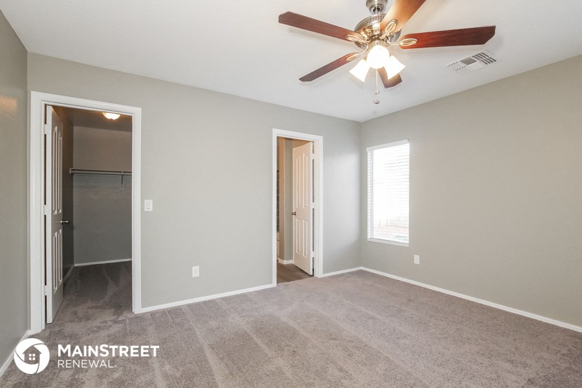 the master bedroom is spacious and has a ceiling fan