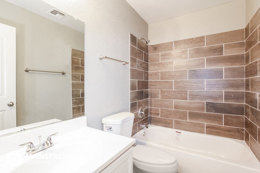 a bathroom with a sink toilet and shower and a bath tub