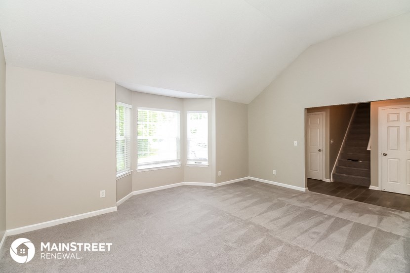 the spacious living room with stairs to the upper level