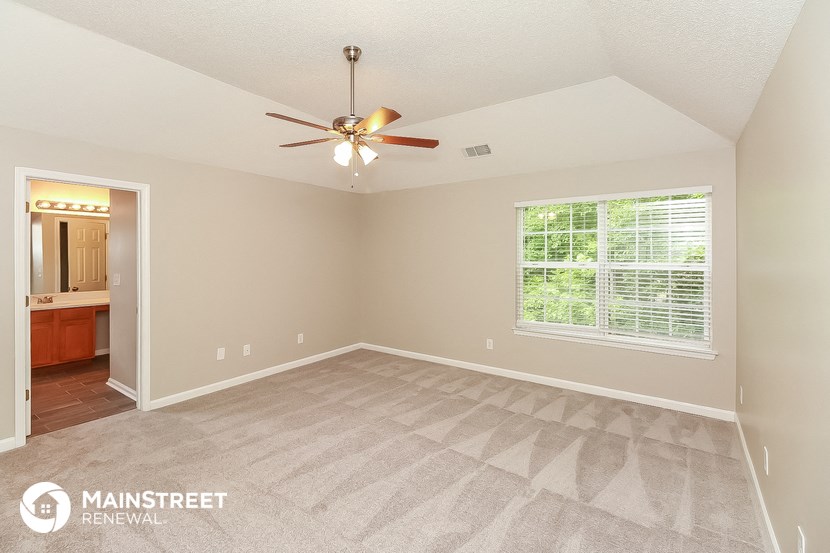 the master bedroom is spacious and clean and has a ceiling fan