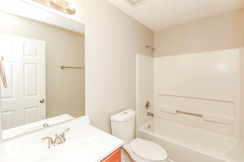 a bathroom with a sink toilet and a bath tub