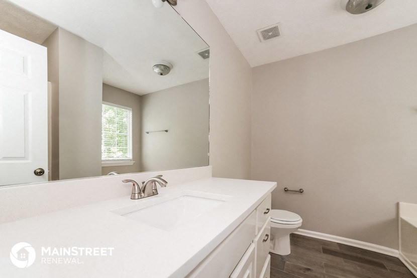 a bathroom with a sink and a toilet and a mirror