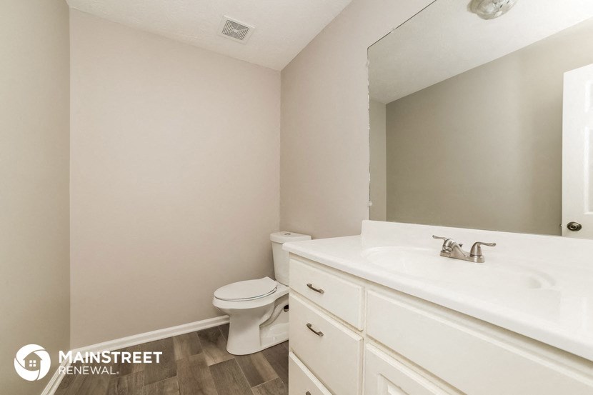 a bathroom with a sink and a toilet and a mirror