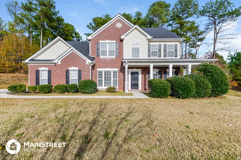 a red brick house with white siding and white shutters