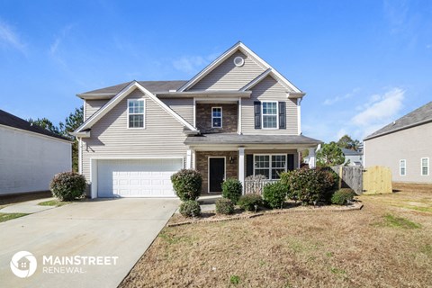 a beige house with a white garage door