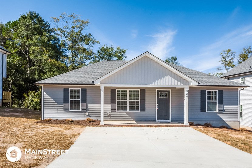 a blue house with a sidewalk in front of it