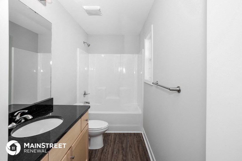 a bathroom with a sink and a toilet and a shower