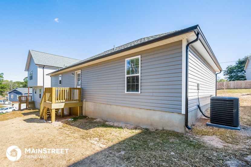 the outside of a house with a porch and a deck