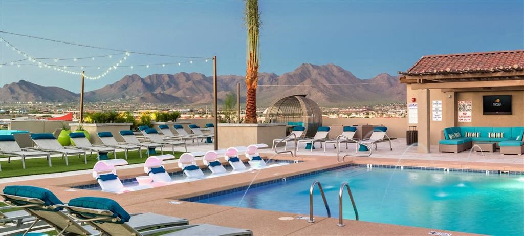 a swimming pool with a view of the desert and mountains