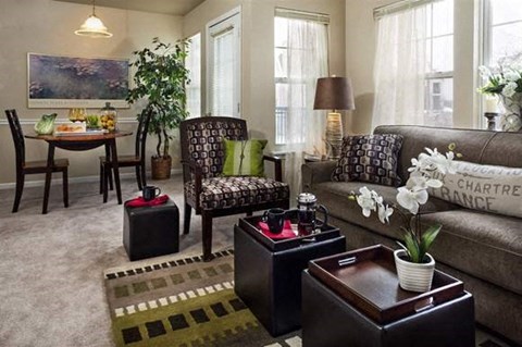 a living room with a couch and chairs and a table