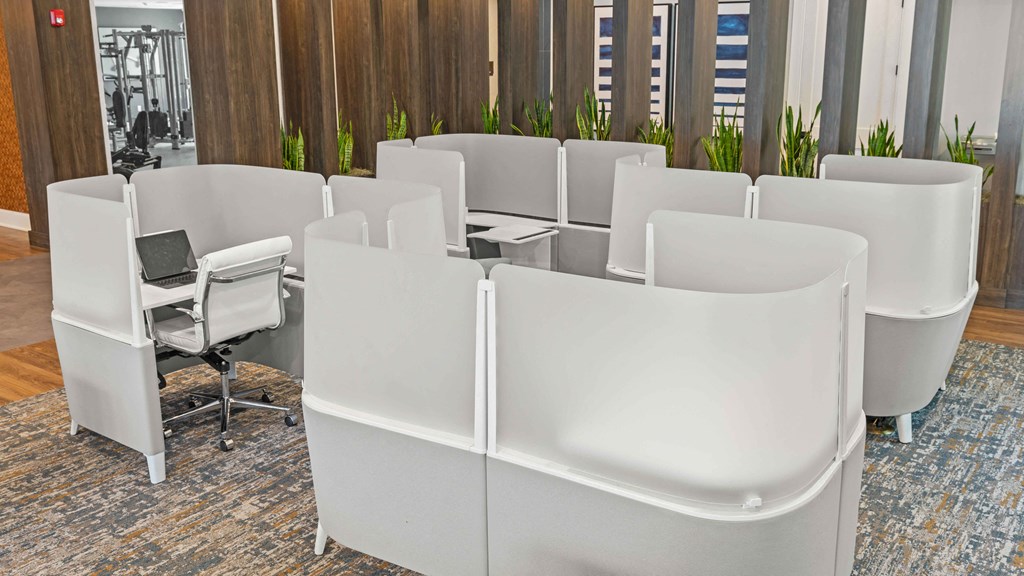 a group of white chairs around a table in an office