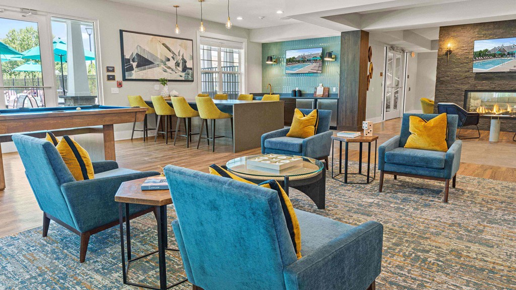 a lobby with chairs and tables and a bar