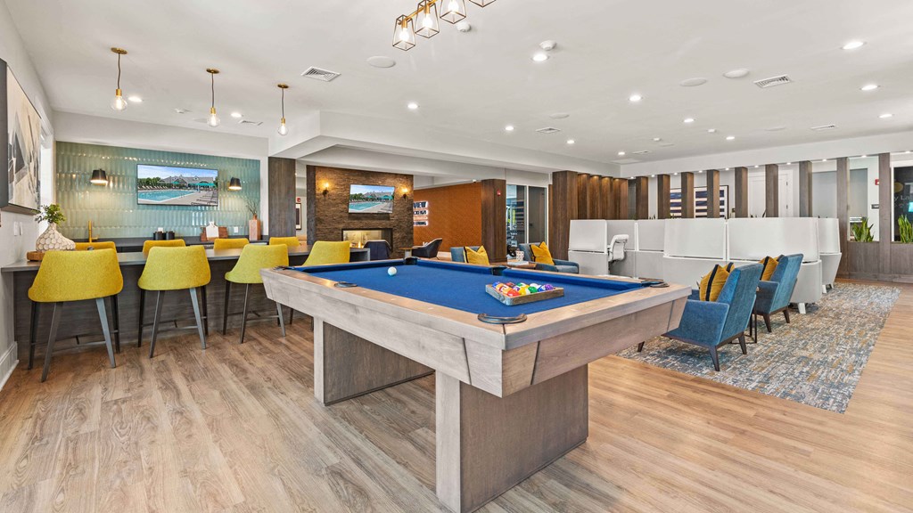 a clubhouse with a pool table and a bar