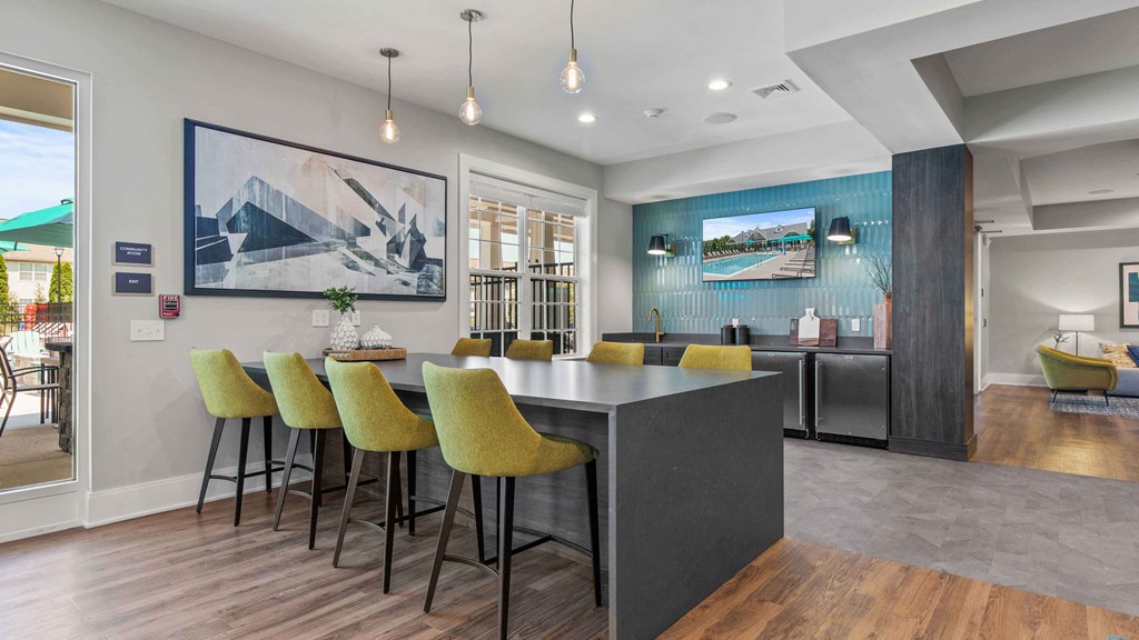 a dining area with a table and chairs and a kitchen