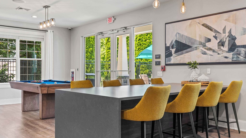 a dining room with a table and chairs and a pool table