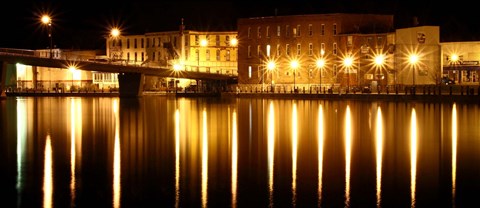 a city at night with its lights reflected in the water