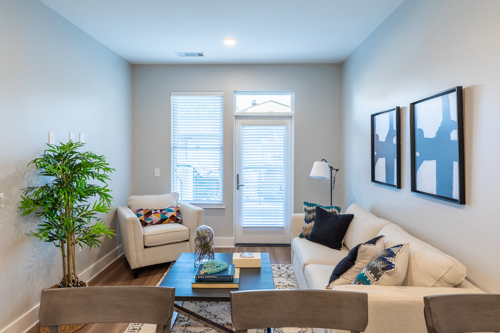 a living room with a couch and chairs and a coffee table
