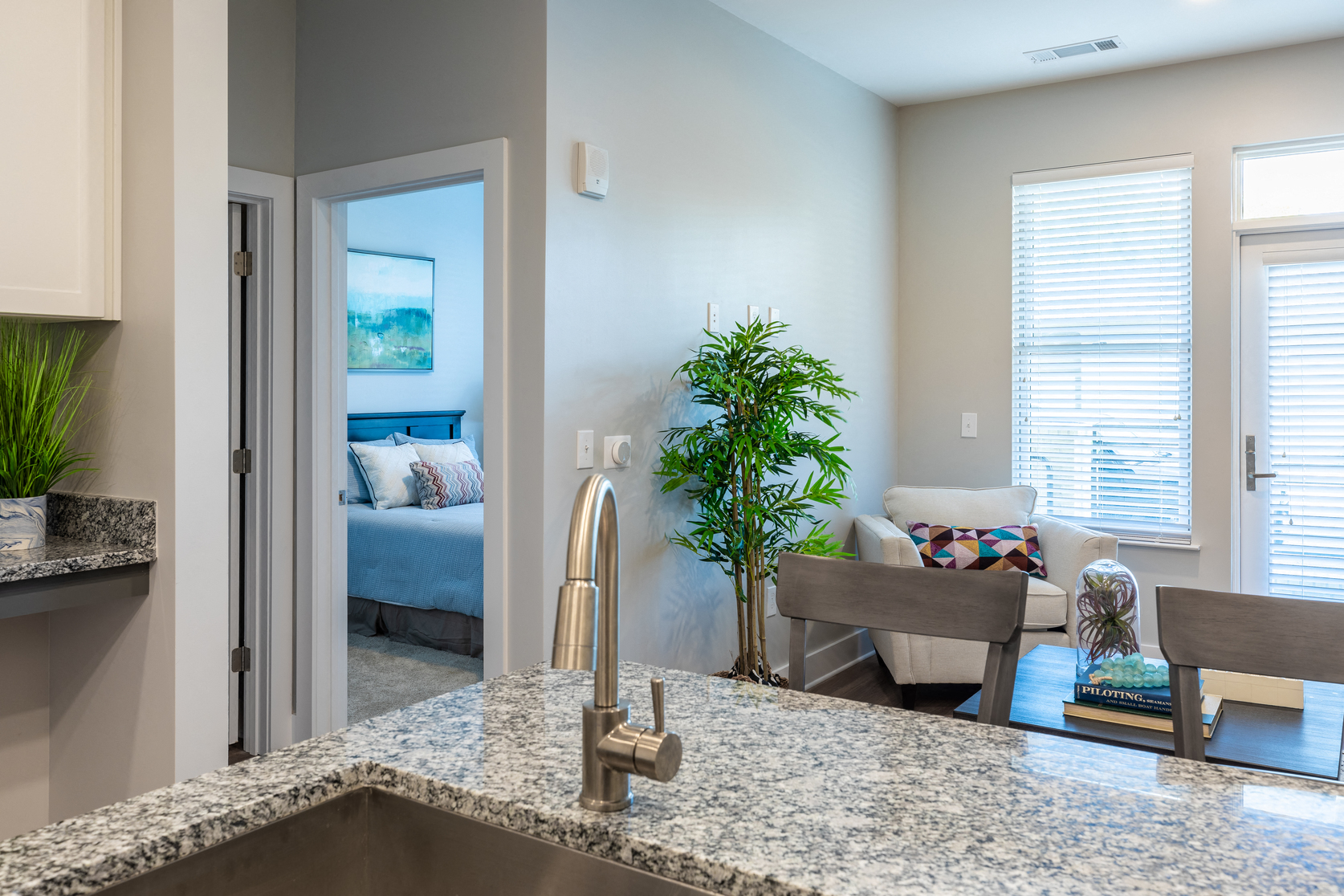 a kitchen with a sink and a view of a living room
