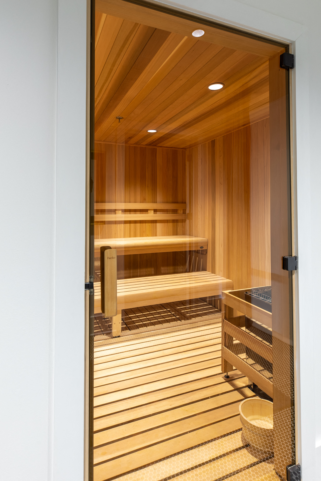 a sauna room with wooden floors and benches