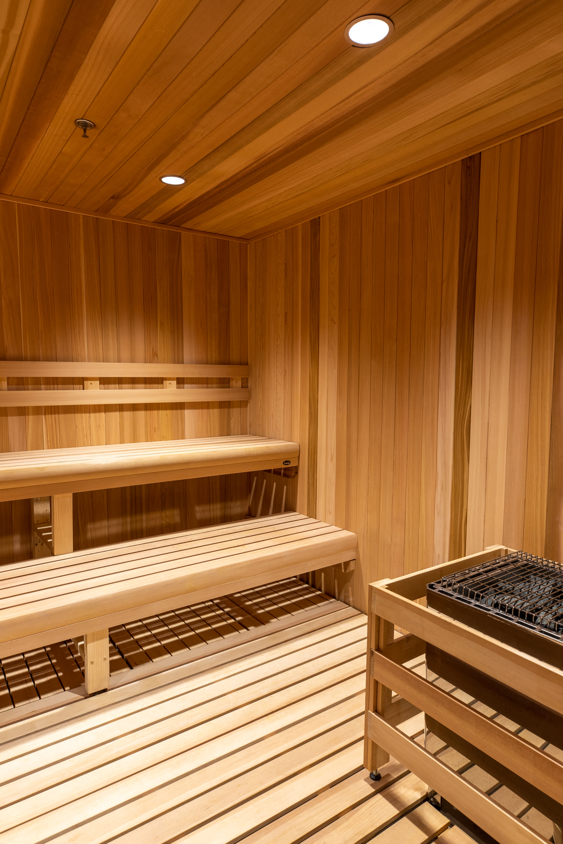 a sauna with wooden benches and a table