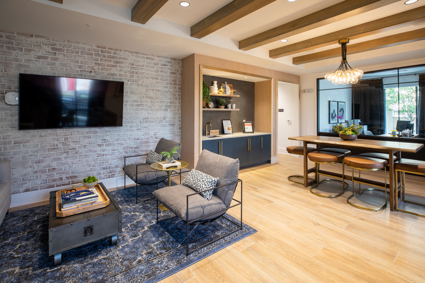 a living room with a brick wall and a tv