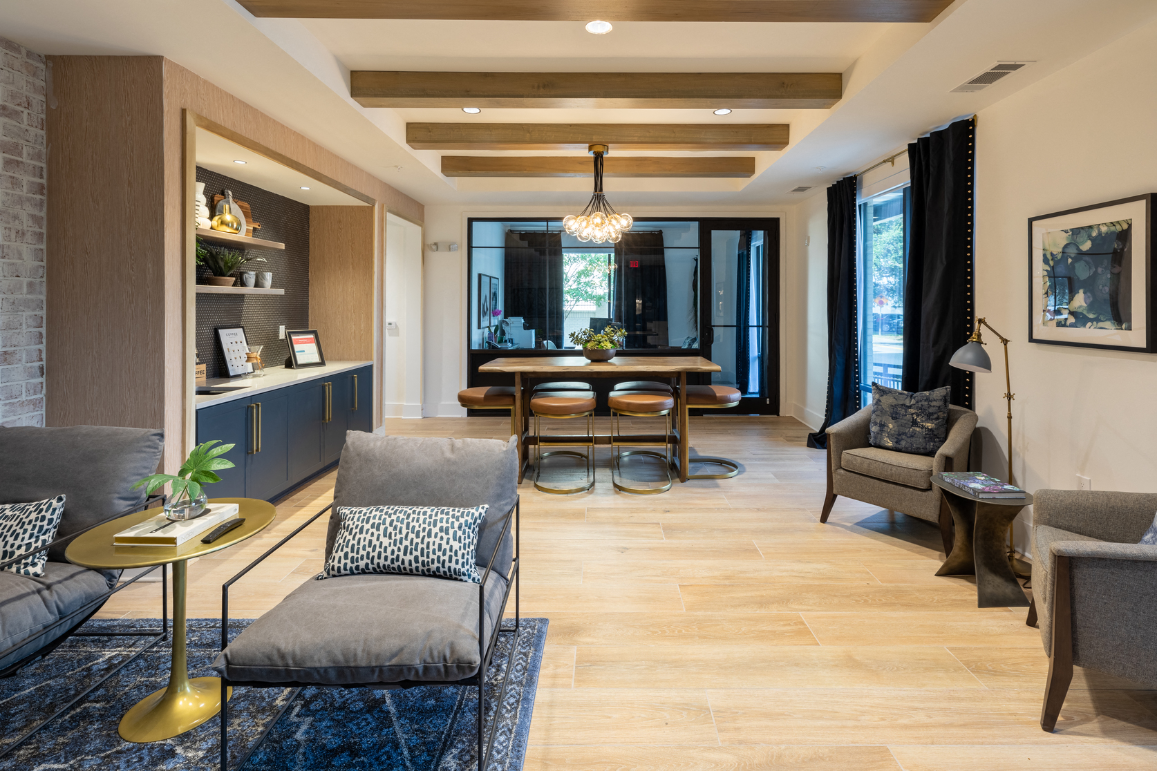 a living room and dining room with a table and chairs