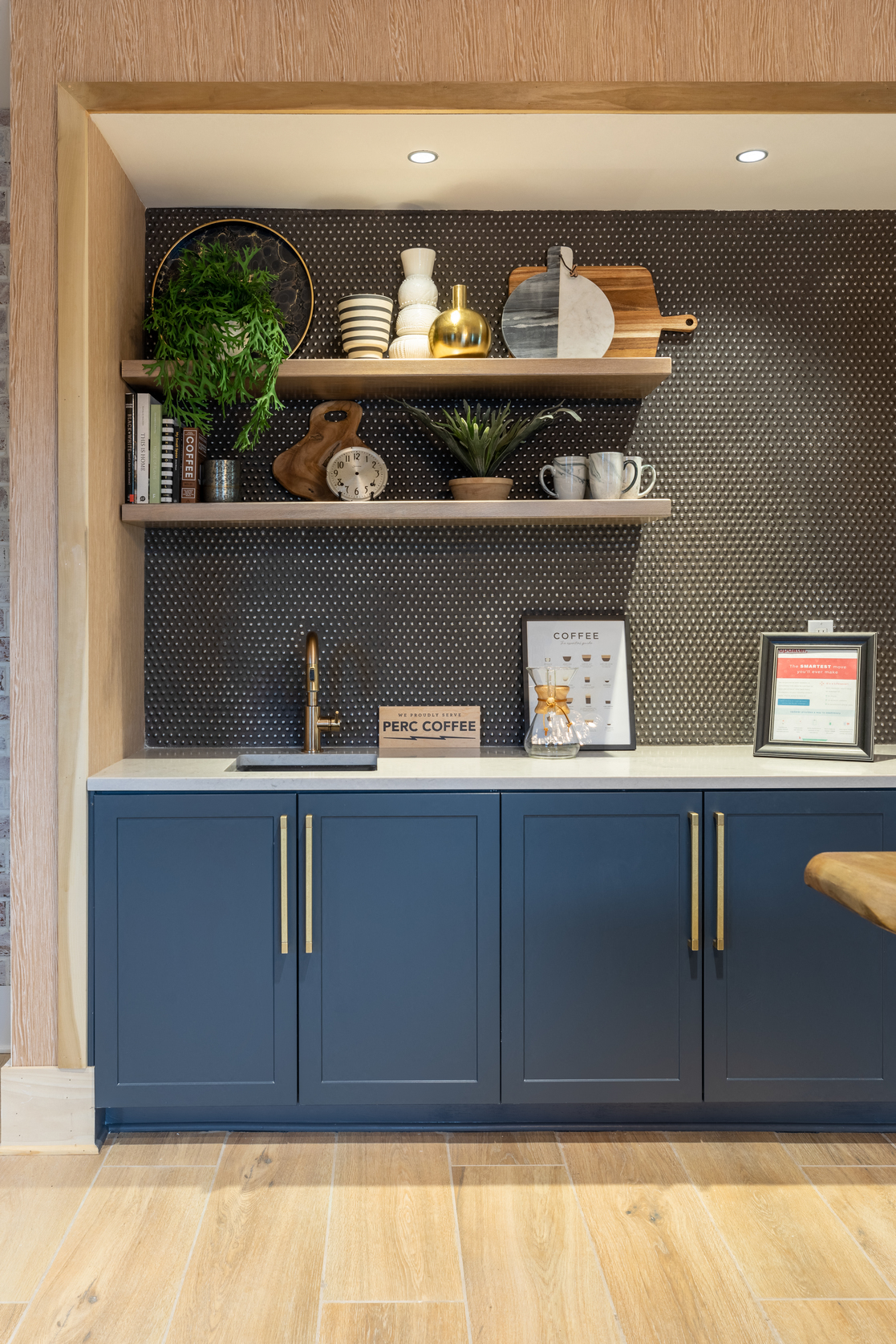 a kitchen with blue cabinets and a counter top and shelves