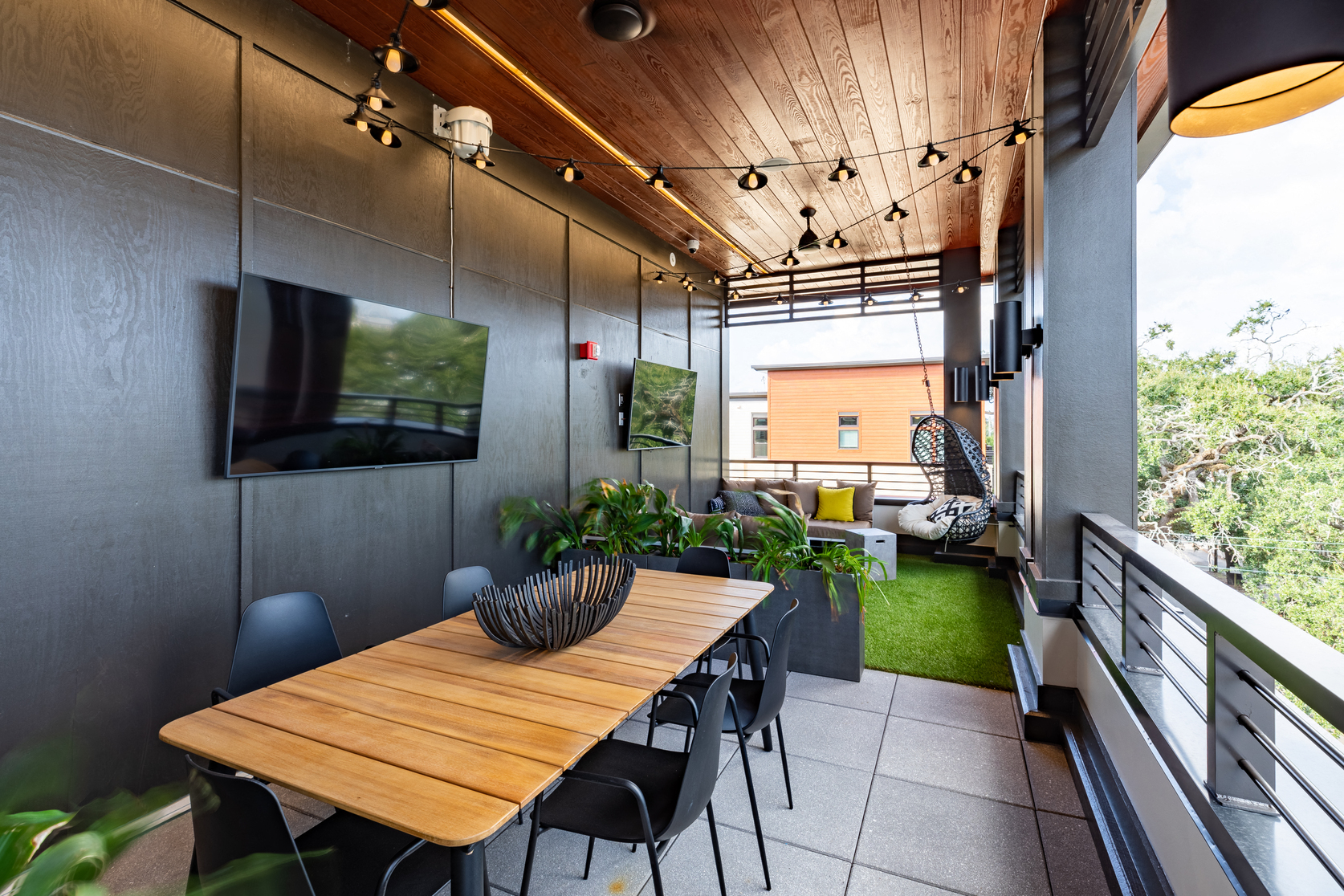 a dining room with a wooden table and black chairs