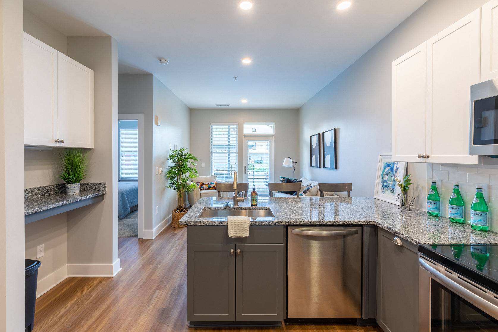 an open kitchen and living room with a large counter top