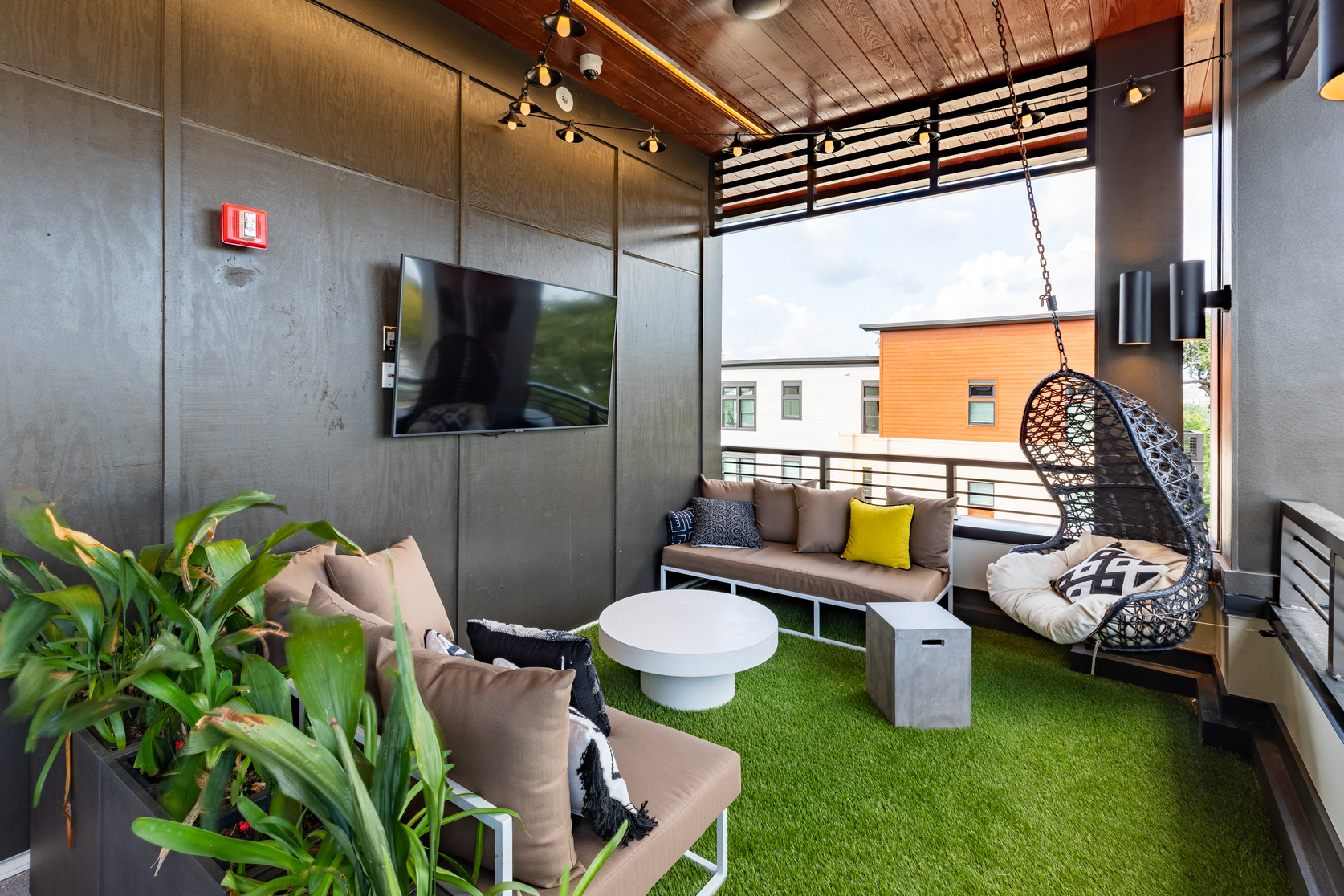 a living room with couches and a tv on the wall