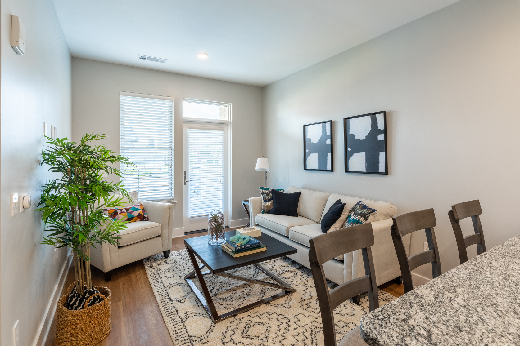 a living room with a couch and chairs and a coffee table