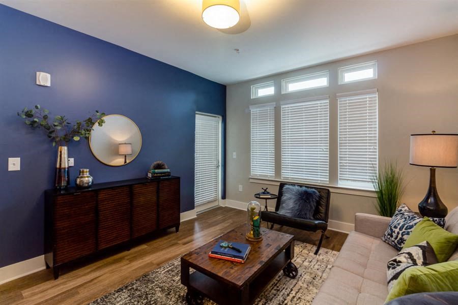 a living room with a blue wall and a couch and a table