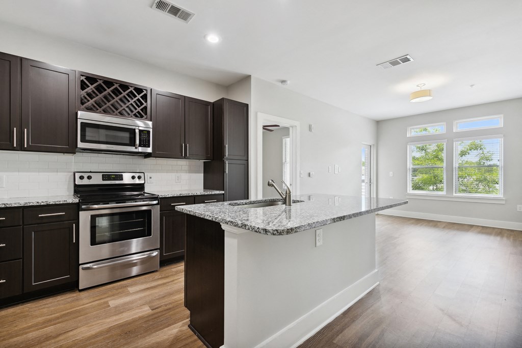 a kitchen with an island and stainless steel appliances