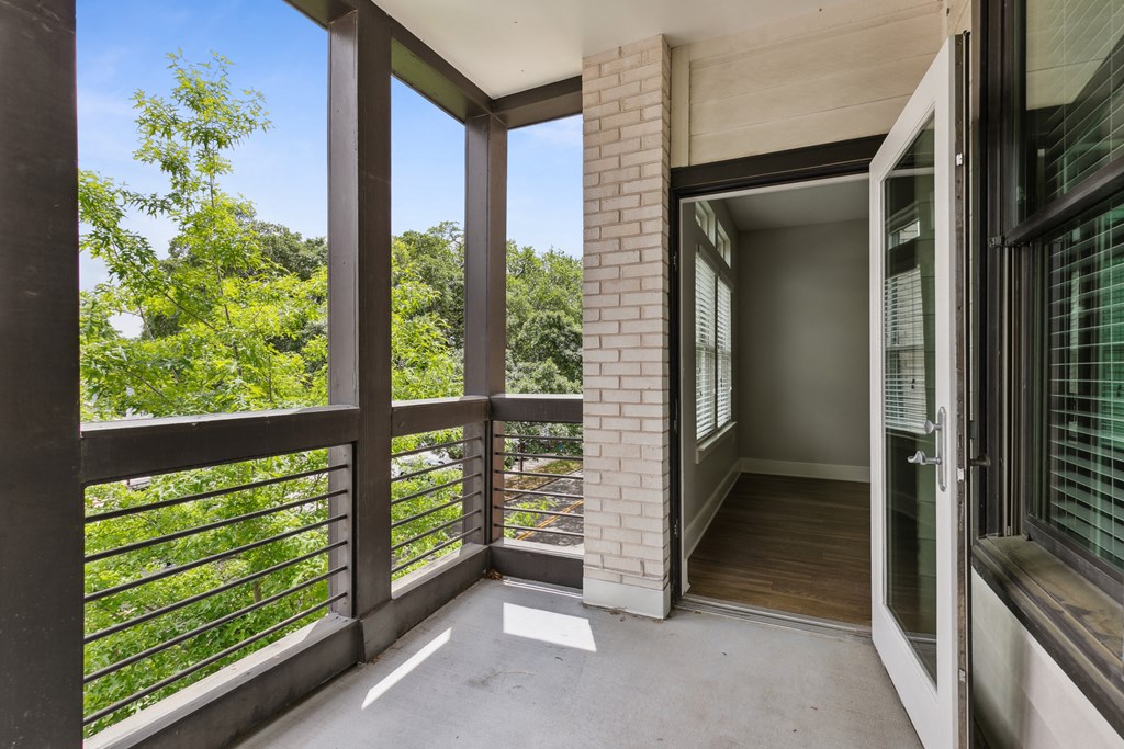 the view from the balcony of a home with large windows