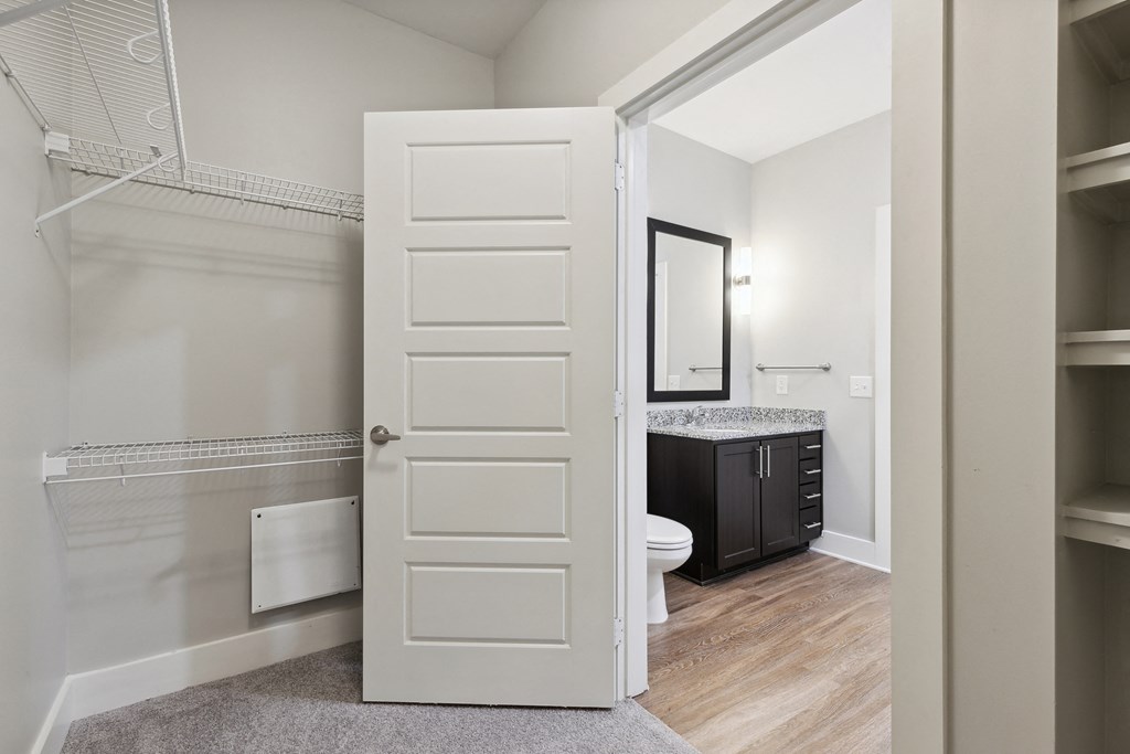 a bathroom with a toilet and a walk in closet