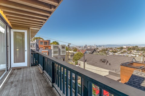 A balcony with a view of the city.