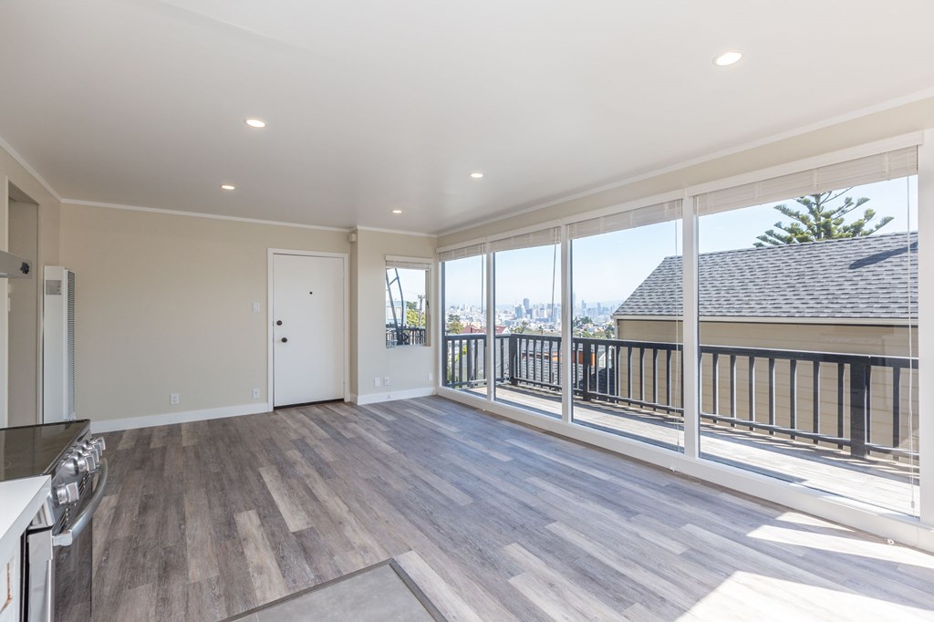 a living room with a large window and a balcony